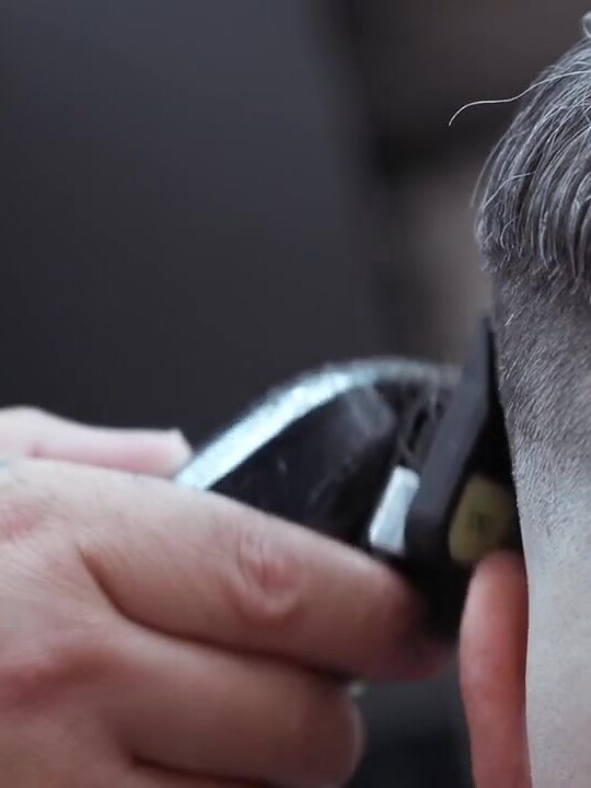 Close-up clipper work on a skin fade